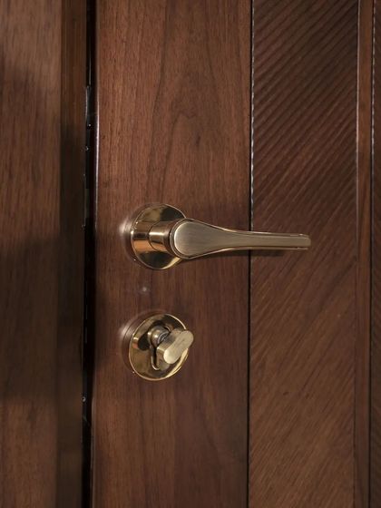 A detail shot of the hardware on the American walnut door, complementing the rich wood tones.
