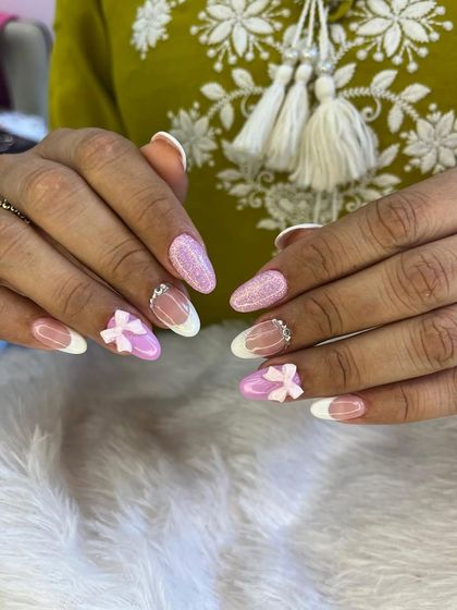 A sweet and feminine design featuring a classic white French manicure. I added glittery pink accent nails and adorable 3D pink bows for a playful touch.