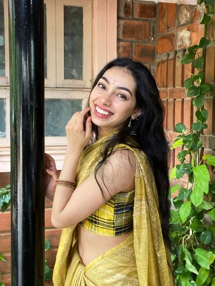 A bright, happy smile in a yellow saree. This shows my cheerful and approachable side.