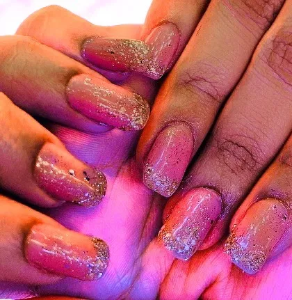 A soft and pretty look using a pink gel base with a delicate gold glitter fade on the tips. This style of ombre glitter nails is a popular choice for adding a touch of sparkle without being too bold.