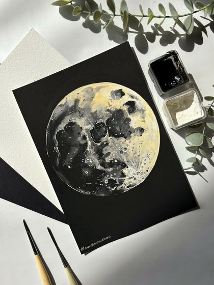 Another angle of my moon painting, showing the art supplies I used. This piece was a fun challenge and a great way to practice my gouache techniques.