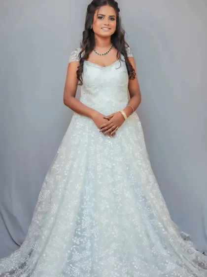 A classic and beautiful white gown, perfect for a Christian wedding or a sophisticated reception look.