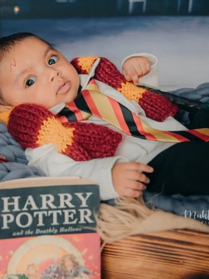 Awake and ready to cast a spell. This little wizard is looking right at the camera in his magical Harry Potter setup.