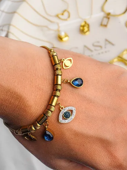 A detailed close-up of a charm bracelet, showcasing the fine craftsmanship and unique design elements. Macro photography like this is crucial for jewellery brands to highlight the quality and detail that customers look for.