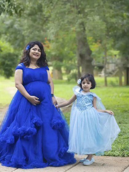 A heartwarming mother-daughter maternity shoot. I offer outfits for the whole family, like this matching blue ball gown for mom and a little princess dress for her daughter.