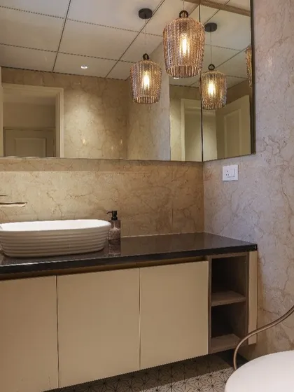 A modern bathroom vanity designed with a premium matt laminate finish for a subtle, sophisticated look. The handleless cabinet doors and open side shelving provide a clean, uncluttered appearance while offering practical storage.