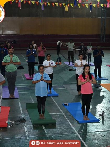 The community stands in prayer pose (Pranamasana) at the start of our sun salutation event. We begin our practice with intention and gratitude.