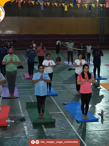 The community stands in prayer pose (Pranamasana) at the start of our sun salutation event. We begin our practice with intention and gratitude.