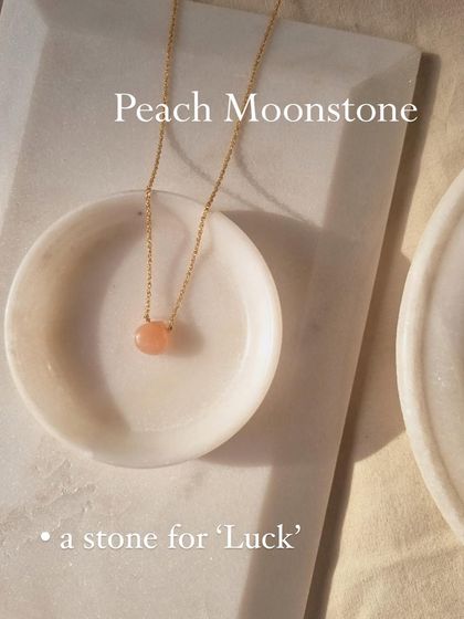 The 'Badamcha' Peach Moonstone heart-shaped drop pendant is a stone for luck.
