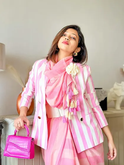 A confident pose, showing how the blazer gives the saree a completely different silhouette.