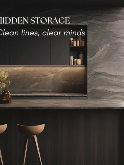 Hidden storage is key to a minimalist kitchen, creating clean lines for a clear mind. This design uses handleless cabinets and a dark, natural stone finish to create a dramatic and uncluttered look.