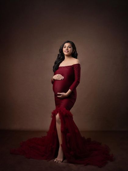 A confident and radiant portrait. The simple act of holding the bump connects the mother to her baby in a powerful, visual way.