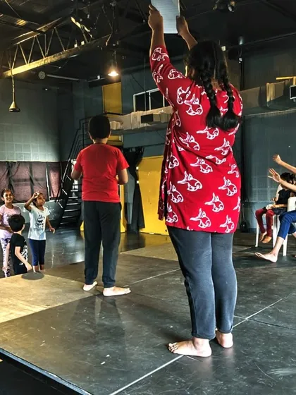 A facilitator guiding our young actors on stage. Our open floor plan allows for dynamic and interactive learning sessions.