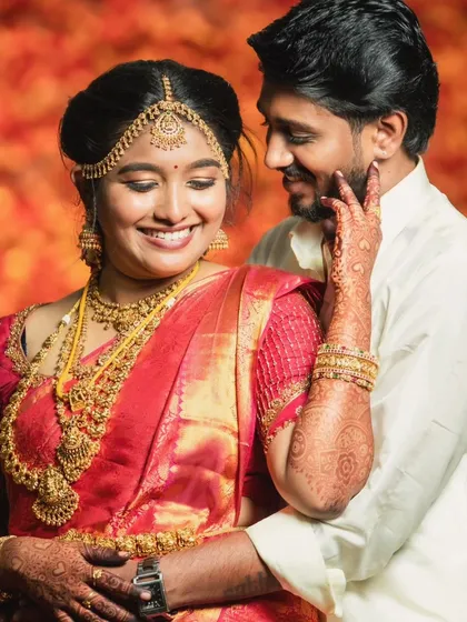 A sweet moment between the bride and groom. Her makeup looks stunning, even in a candid shot.