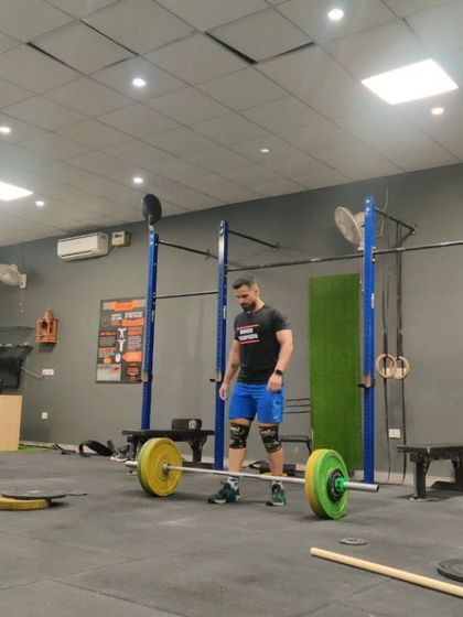 Setting up for a deadlift. A proper setup with a neutral spine and engaged lats is the first and most important step for a safe and powerful lift.