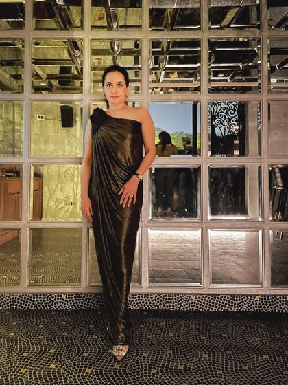 This draped, off-shoulder dress is a perfect example of how a simple silhouette with one interesting detail can look incredibly elegant. It's a style that is universally flattering and effortlessly chic.