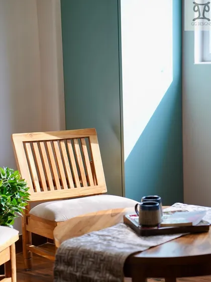 The seating area in the study room, featuring classic wooden chairs. The natural wood and simple design complement the rich wooden flooring and add to the warm, sun-lit feel of the space.