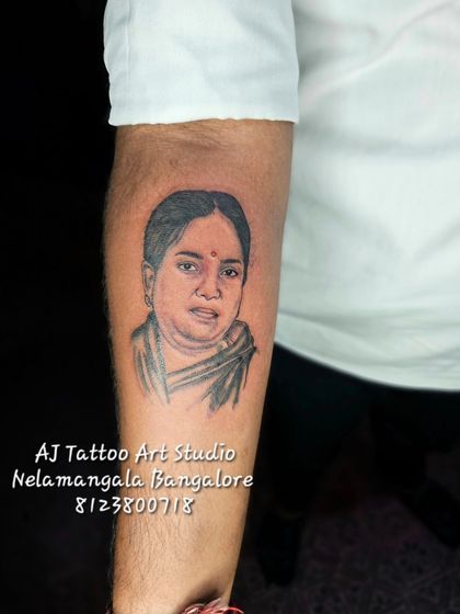 A finished portrait of a mother, inked on the forearm. I use fine lines and shading to bring the photo to life on skin.