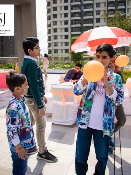 A balloon-blowing race adding to the party fun. Simple, classic games are often the biggest hits, and we have a huge repertoire to choose from.