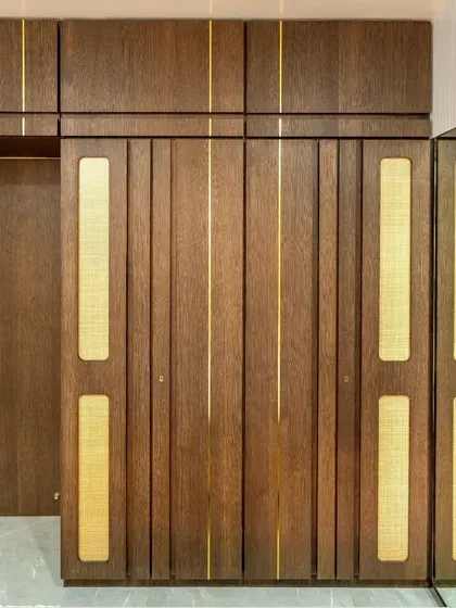 A detail of the wardrobe, made with a veneer finish, gold T-patti, and cane sandwiched between glass to enhance its nuance.