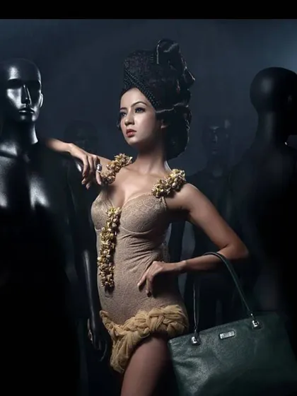 An old-school fashion shoot with a dramatic, sculpted updo and defined makeup. The look is inspired by vintage glamour, created for a campaign featuring fashion accessories.