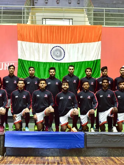 The Indian futsal team kneels for a photo in front of the national flag. We are honored to host national teams as they prepare for and compete in important events.
