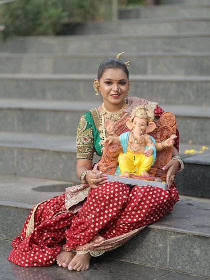 A happy portrait in the red Nauvari, perfect for capturing festive memories.