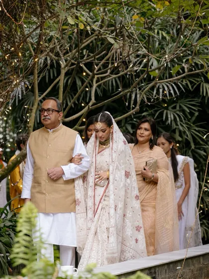 Ramisa walks to her nikaah ceremony with her arm in her father’s, her mother and sister following closely. This is a beautiful portrait of family unity and support on the wedding day.