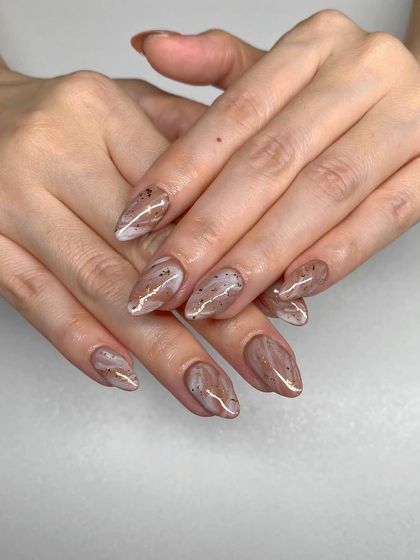 A soft and elegant marble design in shades of brown and white with a sprinkle of gold flakes.