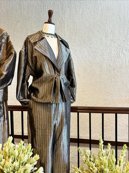 A display of metallic, textured co-ord sets with draped and structured silhouettes, offering a futuristic take on festive wear.