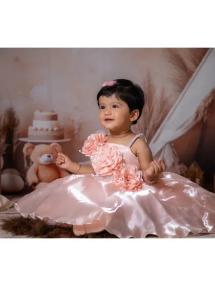 A beautiful little girl in a pink princess dress, enjoying our rustic boho setup.