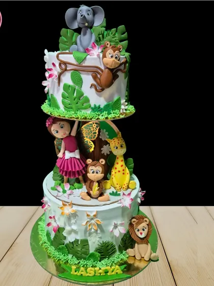 This multi-tiered jungle theme cake is an example of my detailed fondant work. It features a variety of hand-sculpted animals like elephants, monkeys, and lions, creating a vibrant and playful scene for a child's birthday.