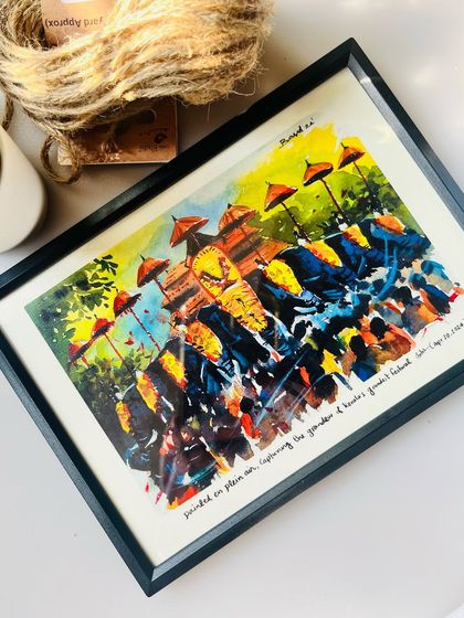 The black-framed 'Thrissur Pooram' print styled with some jute twine and a small plant. I love seeing how my art can fit into different home aesthetics.