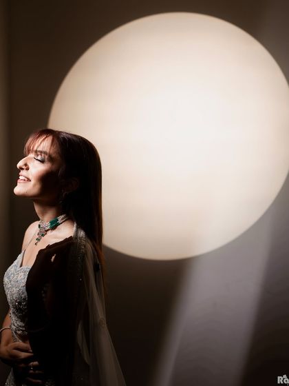 A joyful and serene bridal portrait. The soft light and her happy expression, with eyes closed, capture a moment of pure bliss and anticipation before her wedding.