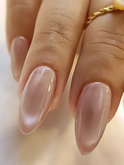Another angle of the nude cat-eye nail, highlighting the smooth, glossy finish and the flawless shaping of the extension.