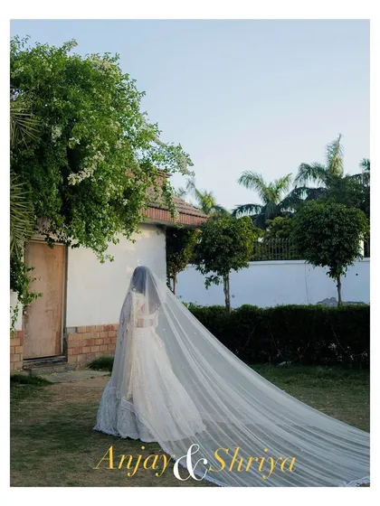 An artistic portrait of the bride-to-be in her engagement gown. The long, flowing veil creates a dramatic and elegant silhouette, showcasing our eye for creative and memorable shots.