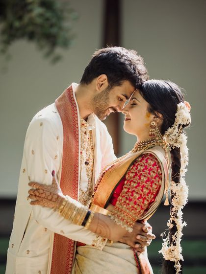 An intimate close-up, with the couple's foreheads touching. The soft light and genuine smiles make this a powerfully romantic and authentic moment.