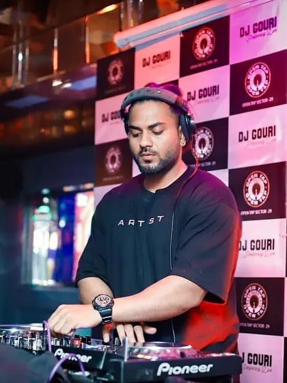 In the zone at Open Tap. You can see my focus as I line up the next track on my Pioneer decks, ensuring the party never stops.