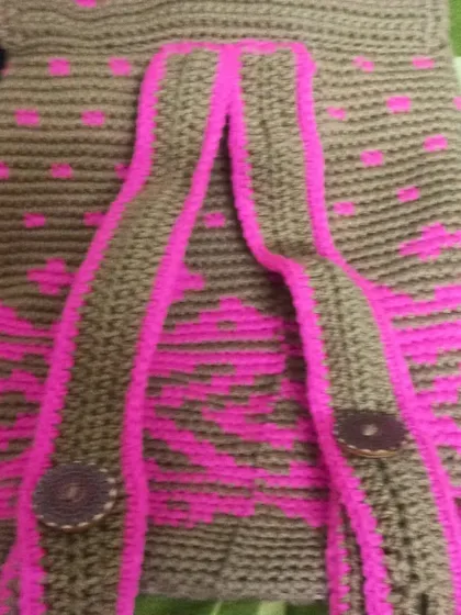 The back of the tapestry backpack, showing the adjustable straps I crochet to match the bag's design.