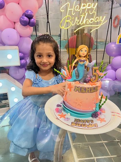 The birthday girl, Meher, dressed as a princess, posing with her lovely mermaid cake for her 5th birthday.