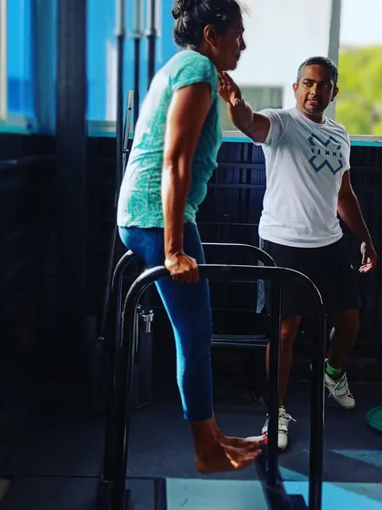 Form comes first, always. Here, one of our coaches provides hands-on guidance to ensure a member performs a dip with correct posture and engagement. We focus on safe progressions to build strength without injury.