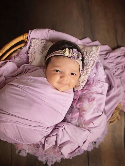 That precious, fleeting smile from a sleeping baby. Wrapped in a lovely lavender swaddle, this little girl's happy dream was a joy to capture.