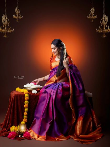 A beautiful composition inspired by classic Indian art. The mother-to-be sits in a traditional setting with brass lamps and flowers, creating a rich and cultural portrait.