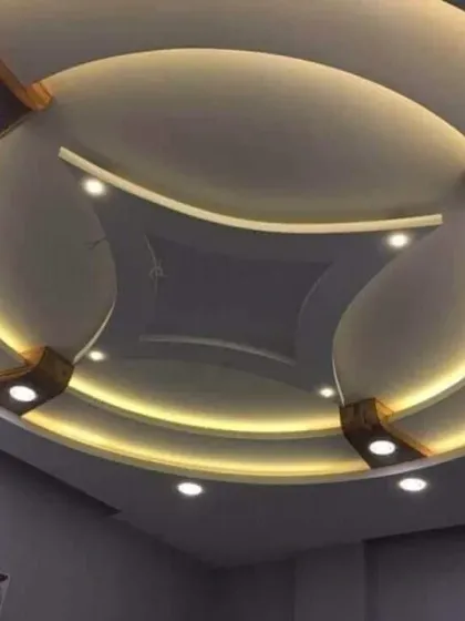 A beautiful circular design with wooden-finish accents and warm cove lighting. This ceiling adds a touch of classic elegance and warmth to the room.