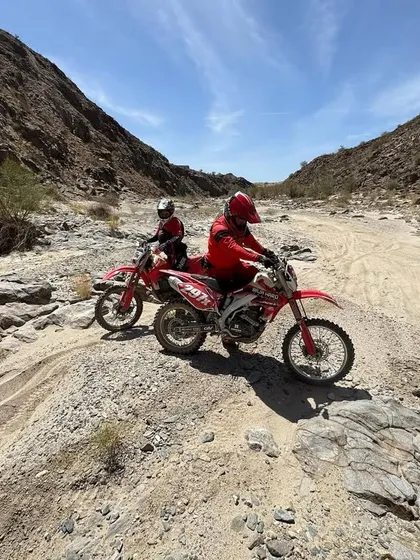 Pre-running the Baja course is critical. Here are two of our riders scouting a rocky wash section, learning the terrain before the race begins.