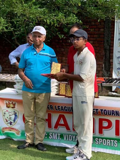 A young player from Gyanti Cricket Academy being honored for his performance in the tournament.