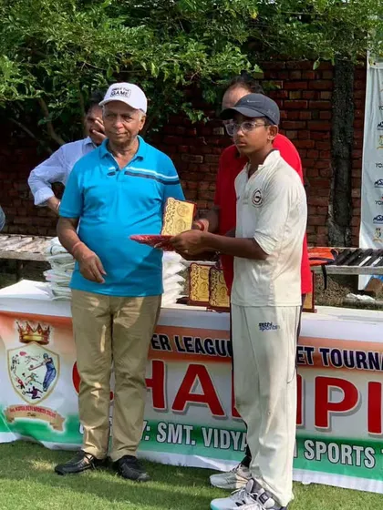 A young player from Gyanti Cricket Academy being honored for his performance in the tournament.