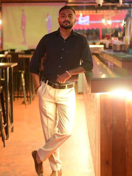 Leaning against the bar in an empty club. This is the calm before the storm, a moment of reflection before the energy of the crowd fills the space.