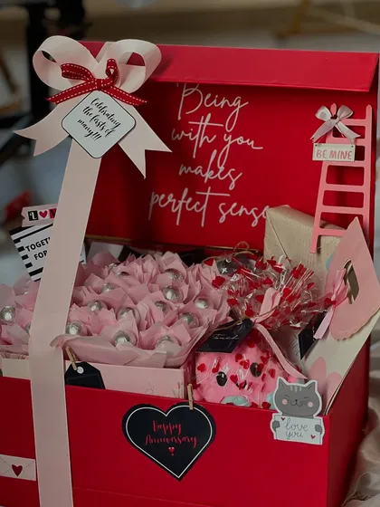 "Being with you makes perfect sense." This large red anniversary box is filled with chocolates and personalized touches, perfect for celebrating a milestone. It works beautifully for Valentine's Day too!