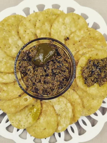 A bowl of my classic Aam ka Achaar served with mathri. The texture of the tender mango pieces mixed with the rich, aromatic masala is perfect for snacking or adding a flavourful punch to your lunch and dinner.